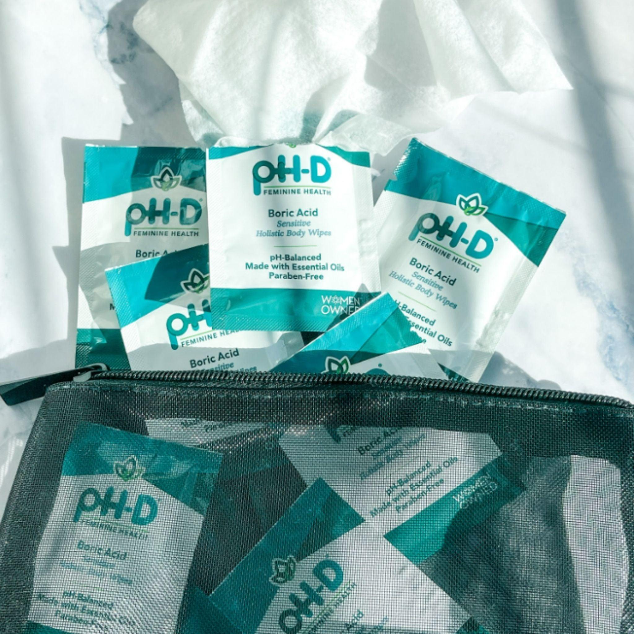 pH-D Boric Acid Holistic Body Wipes packets displayed in a mesh travel pouch with tissues, highlighting portability and convenient feminine hygiene.