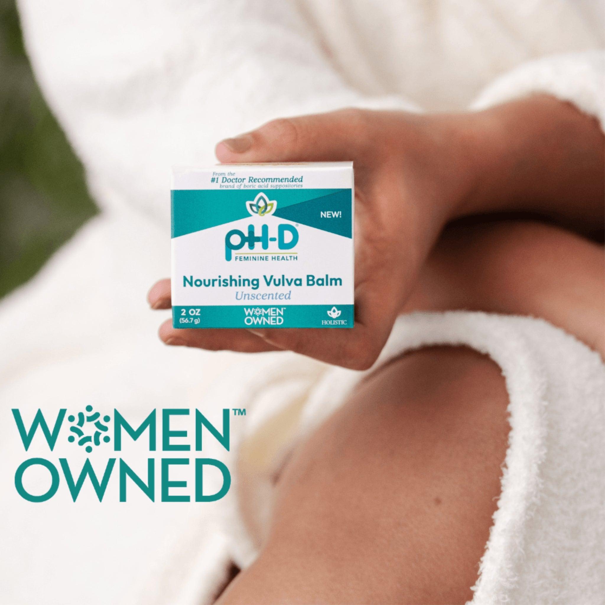 pH-D Nourishing Vulva Balm Unscented packaging held by a woman in a robe, featuring Women-Owned branding and holistic feminine care focus.