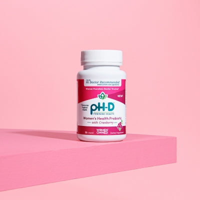 pH-D Feminine Health probiotic supplement bottle displayed on a clean shelf, emphasizing gut and vaginal health benefits.